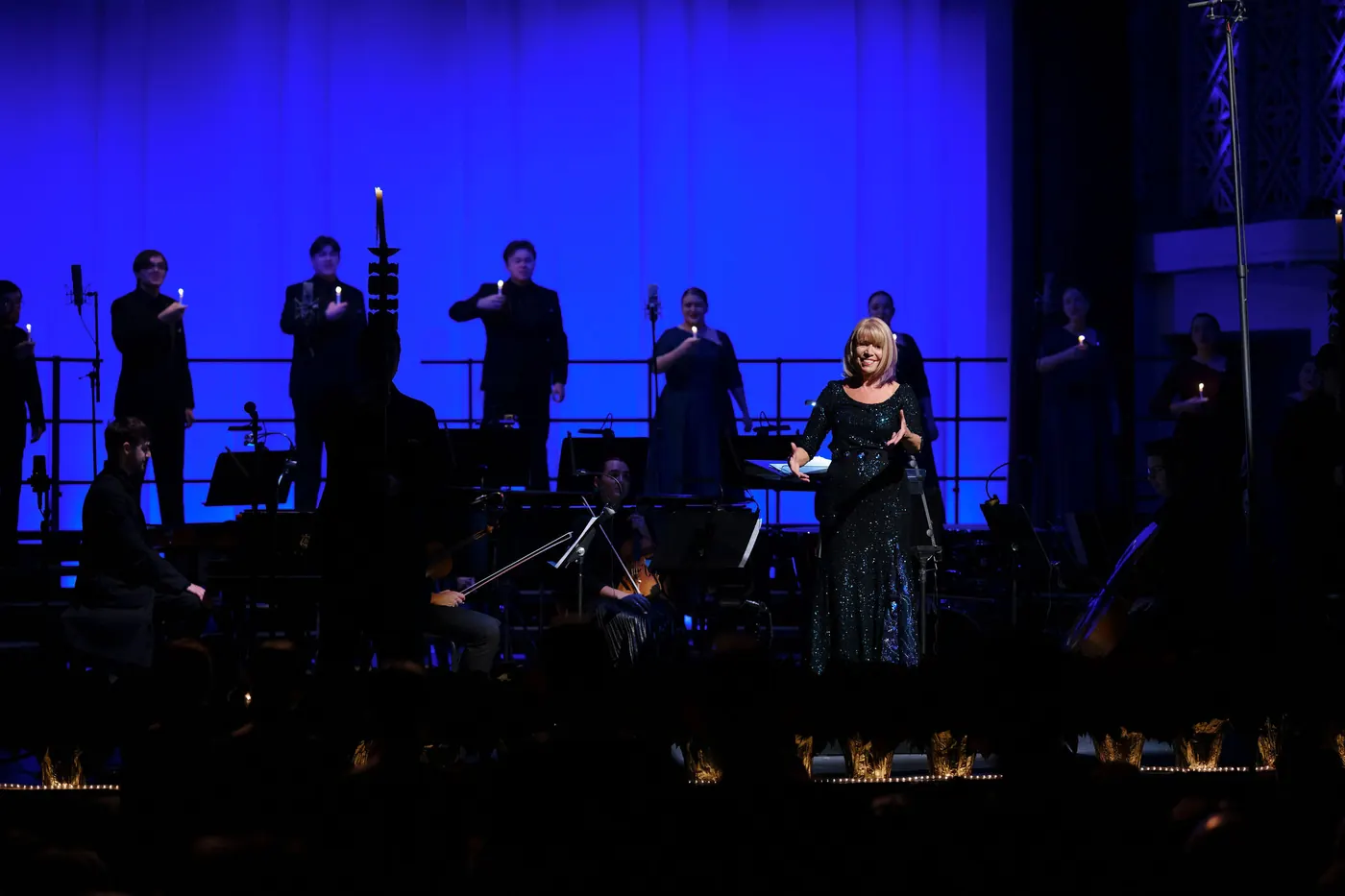 Conducting under blue stage light at the Christmas Festival